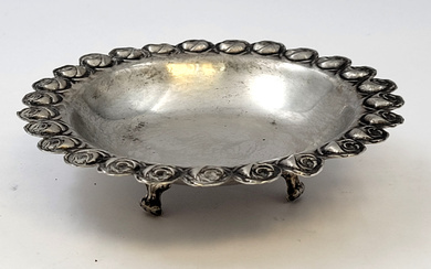 Sterling silver bowl with rose motif. Stands on three legs....