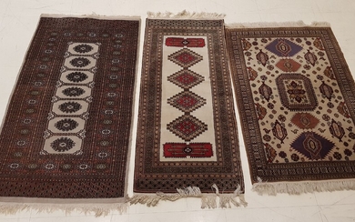 THREE RUGS knotted hands, dominant beige, with geometric decoration one...