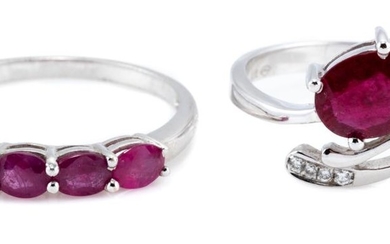 TWO WHITE GOLD RUBY RINGS; an 18ct with oval cut ruby and four small round brilliant cut diamonds, size M, wt. 2.06g, other 14ct set...