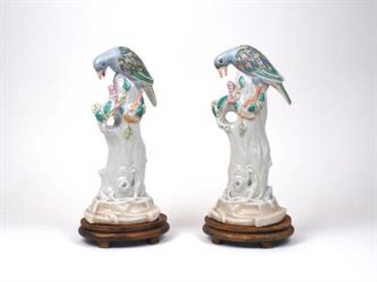 WITHDRAWN Two French Chinese export style models of birds, 19th century, each with colourful wings perched on a leafy branch, on hardwood bases, 34cm high inc bases (2)