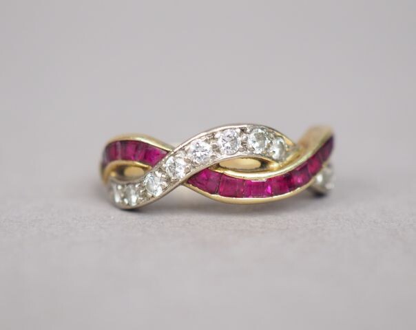 Yellow gold ring set with a line of calibrated rubies interlaced with a line of small diamonds.