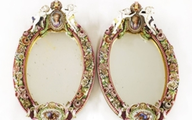 A large pair of Dresden oval mirrors