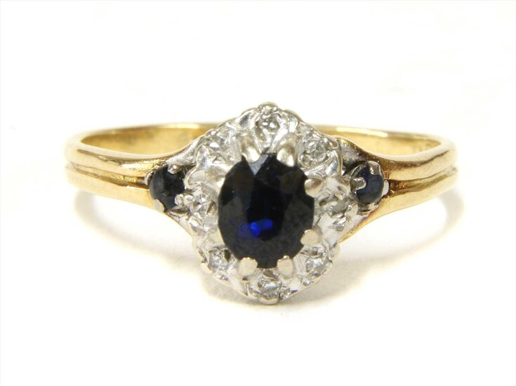 A gold sapphire and diamond cluster ring