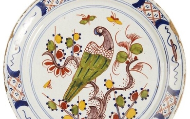 33-Delft: a polychrome earthenware plate featuring a trendy parrot. Wing...