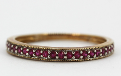 9CT AND RUBY HALF ETERNITY RING.
