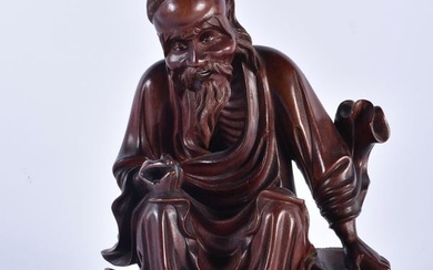 A 19TH CENTURY CHINESE CARVED HARDWOOD FIGURE OF A MALE Qing. 25cm x 14 cm.