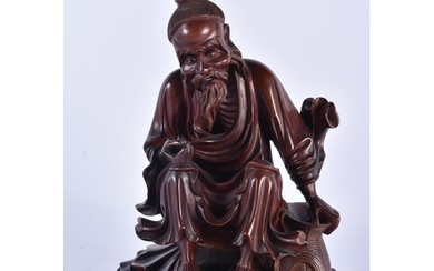 A 19TH CENTURY CHINESE CARVED HARDWOOD FIGURE OF A MALE Qing...