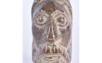 A 19TH CENTURY MIDDLE EASTERN CARVED STONE HEAD OF A SAINT. ...