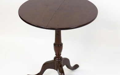 A 19thC mahogany tripod table with a turned pedestal above three cabriole legs. 27" high x 23" in