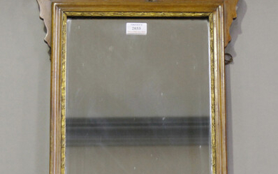 A 20th century George III style walnut and parcel gilt fretwork wall mirror, 70cm x 40cm.