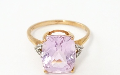 A 9ct rose gold ring set with kunzite flanked by white zirco...