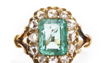 A Belle Èpoque emerald and diamond ring set with an emerald-cut emerald weighing app. 2.60 ct. encircled by numerous rose-cut diamonds. 1900.