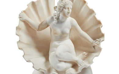 A CARVED ALABASTER GROUP OF VENUS IN A SHELL