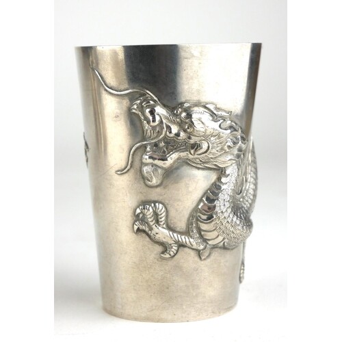 A CHINESE SILVER BEAKER Entwined in relief with a four toed ...