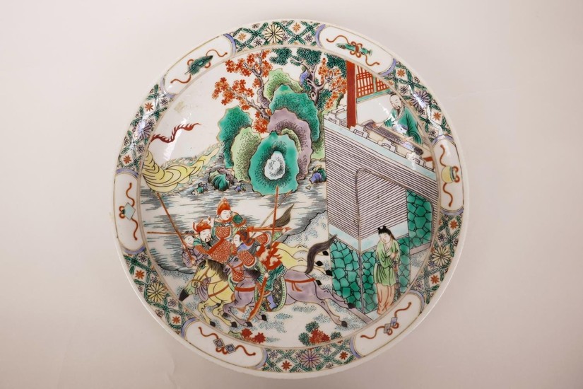 A Chinese famille verte porcelain charger decorated with war...