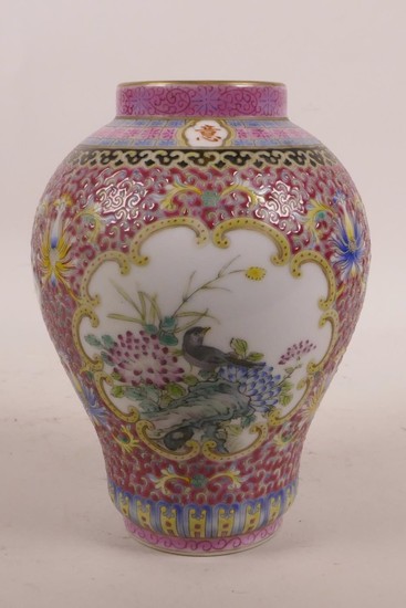 A Chinese polychrome porcelain vase with decorative panels d...