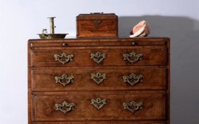 A George I walnut and feather banded chest of drawers, circa 1720