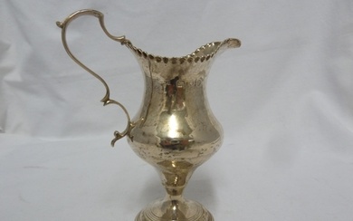 A George III silver cream jug of plain baluster shape with a...