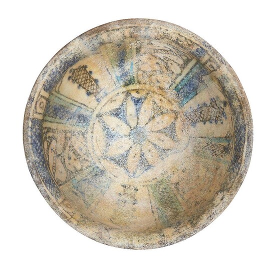 A Mamluk blue, black and turquoise pottery bowl, Egypt or Syria, 13th century, painted to the interior with a flowerhead to the central reserve, surrounded by radiating panels of hatched designs and cobalt blue, 16.4cm diameter Provenance: Private...