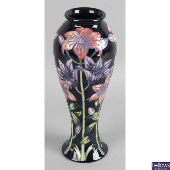 A Moorcroft pottery vase, decorated with lilac and pink flowers.