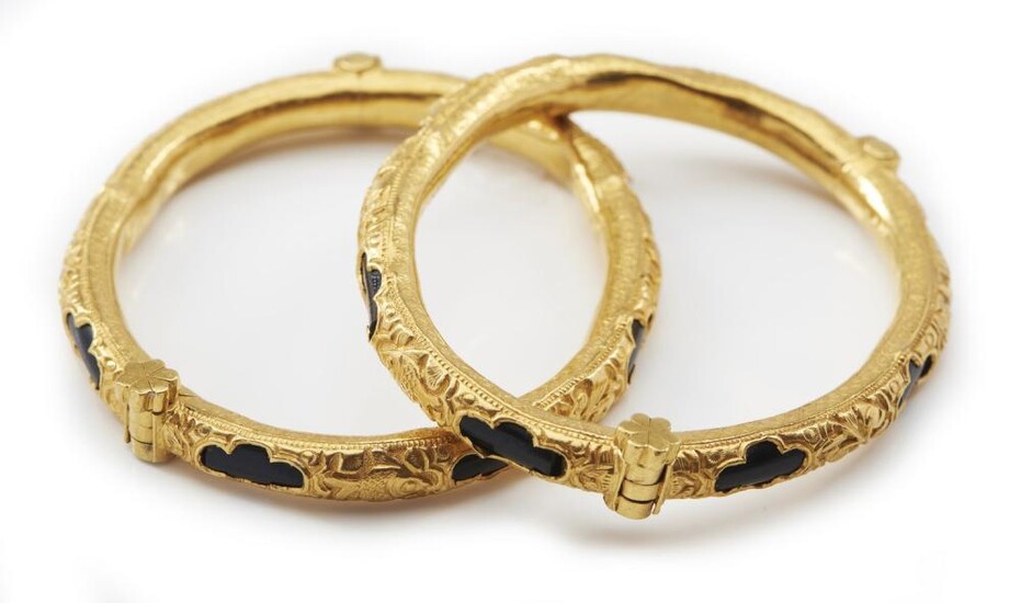 A PAIR OF ANTIQUE GOLD AND BLACK CORAL BANGLES