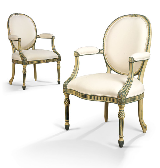 A PAIR OF GEORGE III GREEN AND CREAM-PAINTED OPEN ARMCHAIRS, ATTRIBUTED TO MAYHEW AND INCE, CIRCA 1774