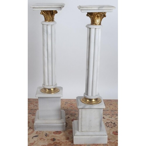 A PAIR OF WHITE VEINED MARBLE AND GILT BRASS COLUMNS each wi...