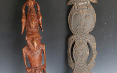 A Papua New Guinea carved and stained wooden figure, height 67cm, together with another figure, heig