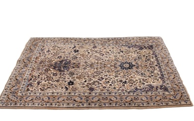 A Persian wool rug in ivory, blue and mushroom colourways, t...