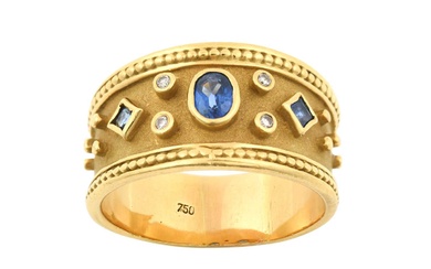 A Sapphire and Diamond Ring the oval cut sapphire flanked...