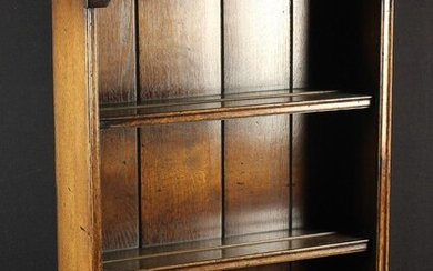 A Set of Small Oak Wall Hanging Shelves with planked back and three shelves beneath a shaped frieze