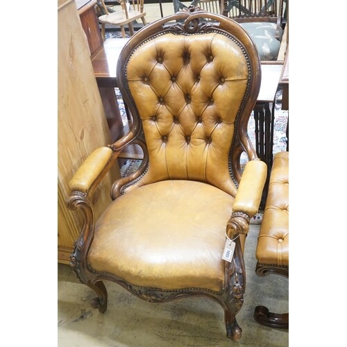 A Victorian carved walnut spoonback open armchair, upholster...