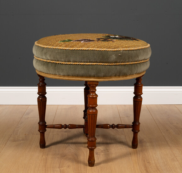 A Victorian walnut circular dressing table stool