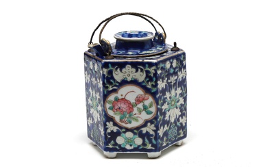 A blue and white porcelain hexagonal ewer painted with flowers blossom on a blue ground