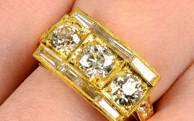 A circular-cut diamond three-stone ring, with vari-cut diamond sides and shoulders.