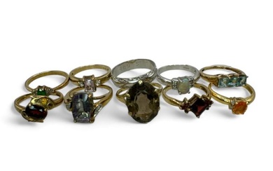 A collection of 9 gem set rings in hallmarked gold,...