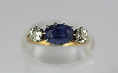 A gold, sapphire and diamond three stone ring