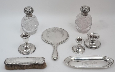 A group of silver comprising: two Victorian silver mounted cut glass vanity bottles, Birmingham, 1892, Horton & Allday, 16cm high; a silver mounted hand mirror, Birmingham, marks rubbed; a silver mounted brush with matching decoration, Birmingham...