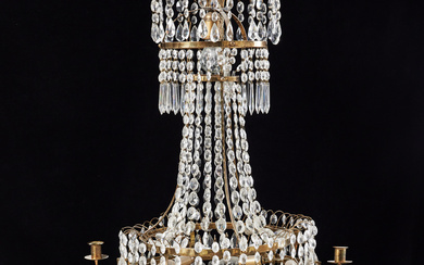 A mid 20th century chandelier, late Gustavian style, for 6 candles, brass frame, hinged with prisms, electrified.