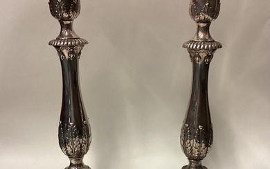 A pair of 18th Century Georgian cast silver candlesticks on square bases.