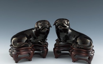 A pair of Chinese black-glazed porcelain dog figures, 19th century