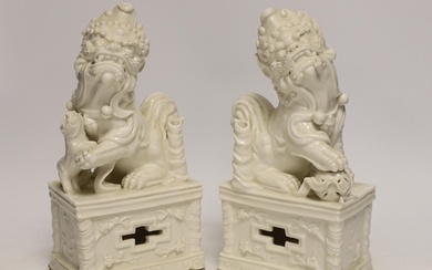 A pair of Chinese blanc de chine lion dogs, 21cm high