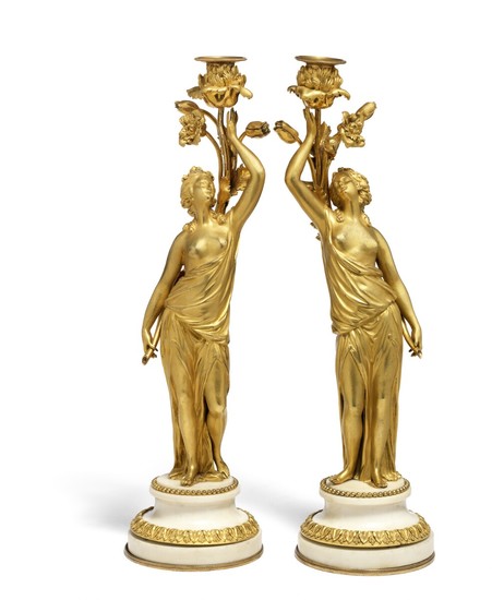 A pair of French gilt bronze and white marble candlesticks. First half of the 19th century. H. 43 cm. (2)