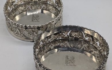 A pair of George III silver coasters, decoration with...