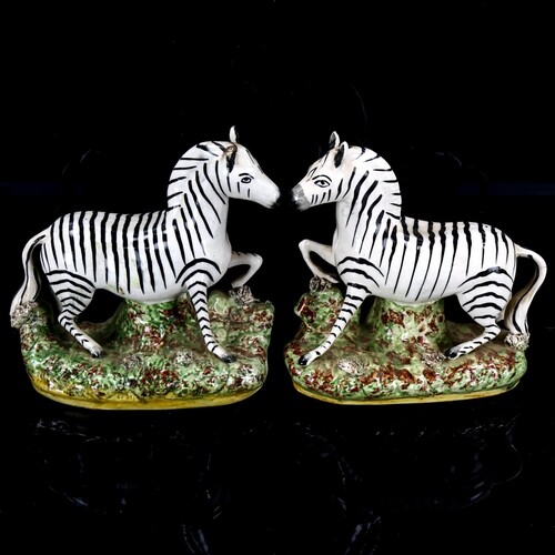 A pair of Staffordshire pottery zebra figures, height 19.5cm