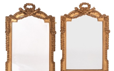 A pair of carved and gilt composition framed wall mirrors in...