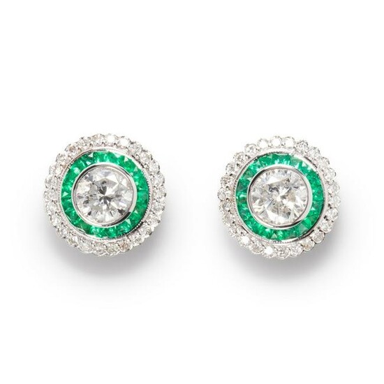 A pair of diamond, emerald and eighteen karat white