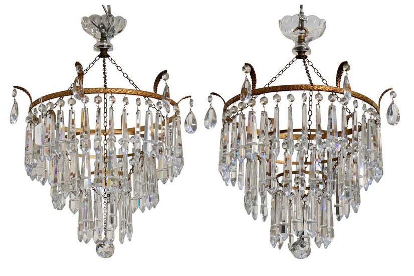 A pair of early 20th Century gilt metal two tier chandeliers