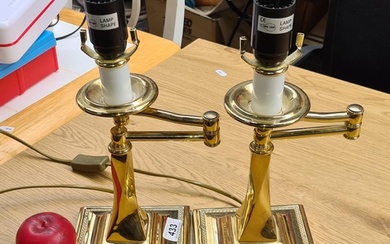 A pair of heavy polished brass table Lamps in the form of ca...