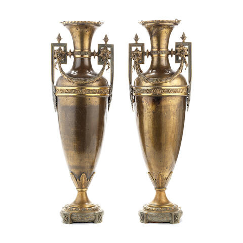 A pair of late 19th / early 20th century patinated and parcel gilt bronze garniture vases in the Louis XVI style
